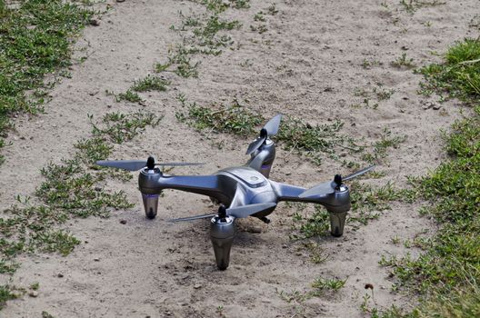 Remote control drone placed on the lawn and ready to fly in the Plana mountain, Bulgaria