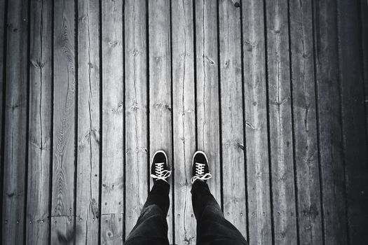 Man standing on the old wooden floor. Travel concept.