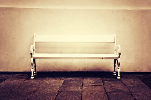 White lonely bench. Vintage retro picture.