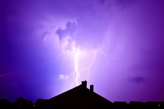 Dramatic sky and storm. Lightning hit the house. Power of nature concept.