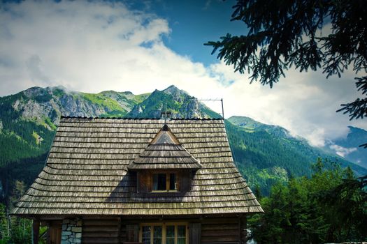 Nature in mountains. Old wooden house in beautiful mountains scenery.