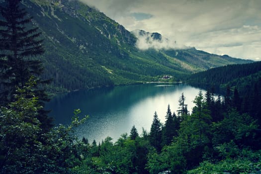 Mountain lake and clouds. Morskie oko in Tatry, Poland. Nature landscape.
