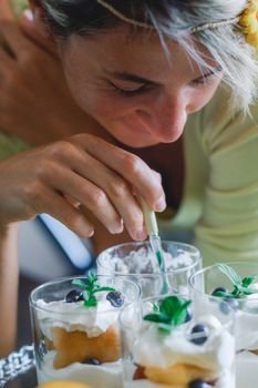 Close-up image of young lady eating dessert.