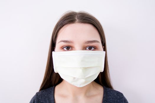 Young woman wears a face mask. Isolated image. Covid-19 concept.