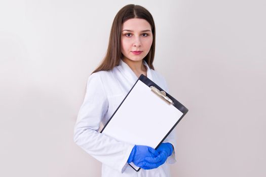 Female doctor wearing protection gloves and holding notes. Free copy space. Covid-19 concept.