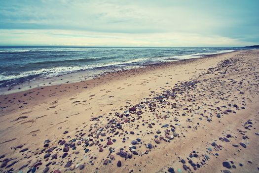 Cold sea in vintage colors. Water sky and beach.