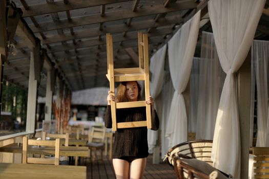 portrait of young girl in black jacket sweater at sunset, summer interior