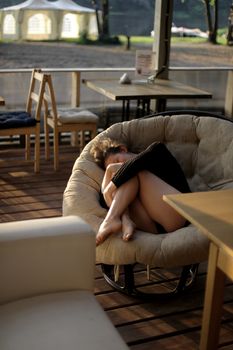 portrait of young girl in black jacket sweater at sunset, summer interior