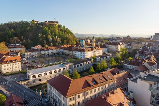 Aerial drone panoramic view of Ljubljana medieval city center, capital of Slovenia in warm afternoon sun. Empty streets during corona virus pandemic social distancing measures.
