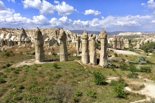 Rural landscape in the Valley of Love, Cappadocia. Large phallic rock formations against the blue summer sky.