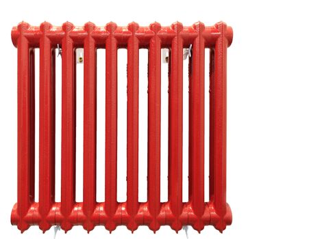 The old cast-iron heating radiator is painted with red paint and is isolated on a white background.
