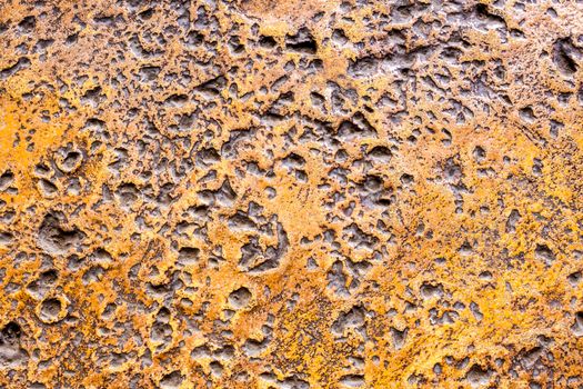 Many rugged holes on the rusty color concrete floor