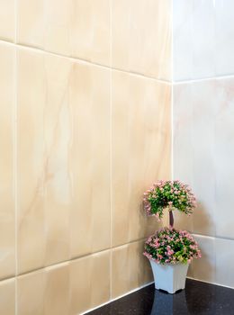 Plastic bouquet in a vase Decorate the wall corner of the wash basin in the shower room