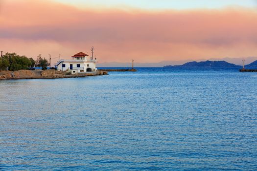 Wide entrance to the Corinth Canal in Greece in the rays of the rising sun and the horizon in the morning sea haze, image with copy space.