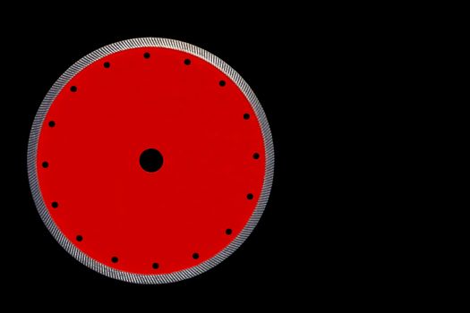 Cutting disc red color with diamond diameter of 230 mm, is used a thin blade for precise cutting of the granite, isolated on the black background, image with copy space.