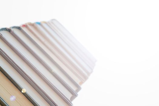 Stack of books in library. Scientific, educational, and fiction paper books. Education and training.