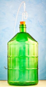 A 22 liter glass jar made of thick green glass with a water lock is the best high-volume glass container for making homemade wine.