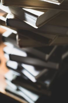 Stack of books in library. Scientific, educational, and fiction paper books. Education and training.