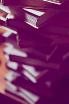 Stack of books in library. Scientific, educational, and fiction paper books. Education and training.