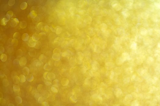 Golden Abstract beautiful bokeh background. Uneven dynamic background of the light effect of the lens.
