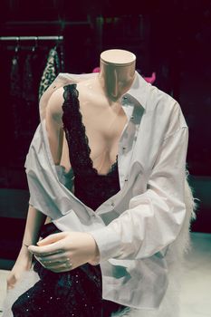 Female mannequin in black underwear. Storefront of women's clothing.