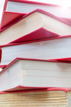 Pile of new books. Books in red covers. Training and education on the pages of books.