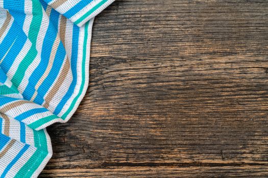 Blue checkered towel on the kitchen table. Wooden kitchen table.