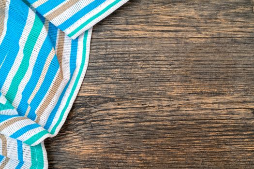 Blue checkered towel on the kitchen table. Wooden kitchen table.