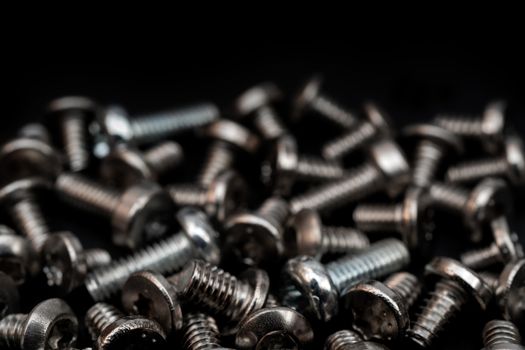 Fixing bolts. Assembly of computers. Technical texture. Dark background.