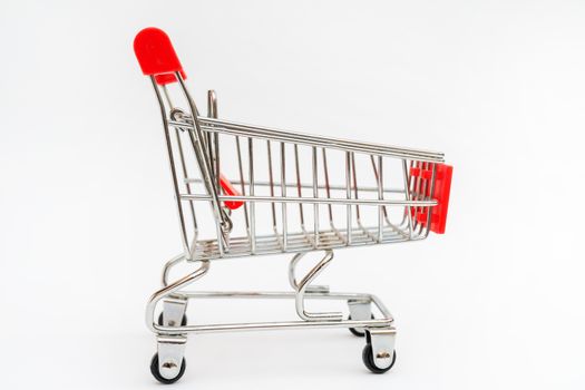 Metal trolley for supermarket. Transportation of products in store. Retail.