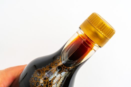 Soy sauce in glass bottle. Traditional asian seasoning.