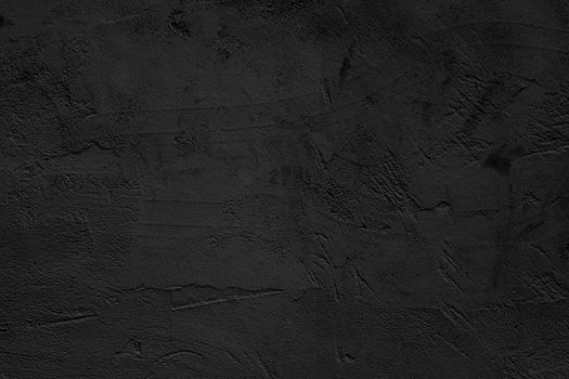 Black abstract background. Black stucco wall of an old house.