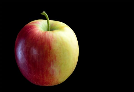 Yellow red ripe, sweet apple isolated on a black background., close-up.