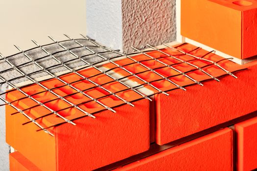 The use of nylon mesh in construction when laying bricks and erecting the walls of the building is shown in the layout. Concept and new technology in the construction industry.