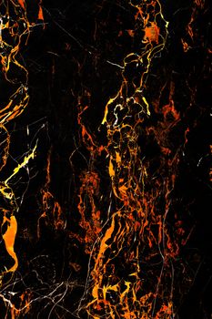 Marble spots, like frozen lava flows on a black marble surface. Black and fiery marble texture.