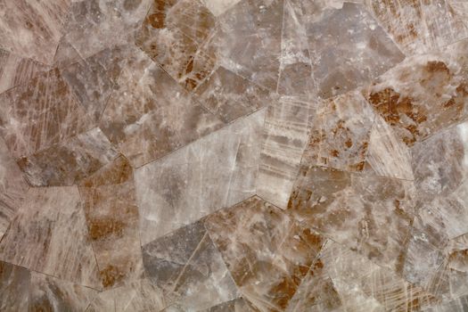 Brown marble tiles with stripes and cracks are selected in shape and connected together into a single surface.