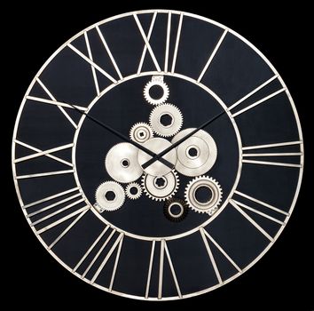 Round industrial wall clock made of white metal and real gears isolated on a black background.