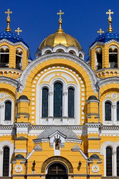 The central facade of the Orthodox Church of St. Vladimir in Kyiv, the central arched windows with a golden dome in the middle against a blue sky, March 29, 2020, Ukraine.