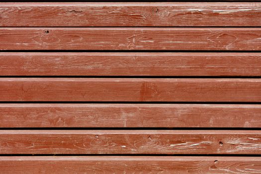 Brown old paint on an eroded shabby wooden horizontal wooden battens, texture of an old wood.