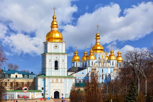 The building of the famous Mikhailivsky Golden-Domed Cathedral with a bell tower in Kyiv in the spring, March 29, 2020 against a blue cloudy sky.