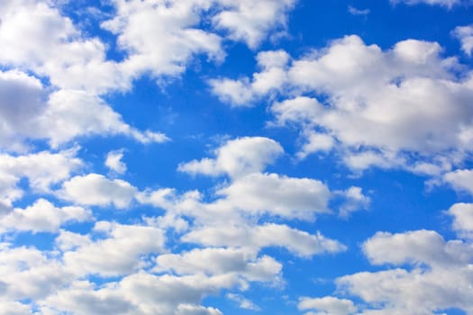 Blue sky with white fluffy clouds floating high above your head.