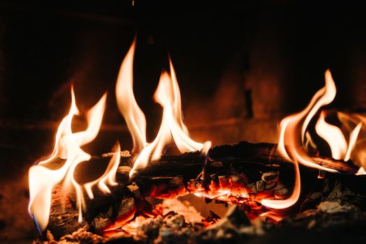 burning smoldering fire in a stone fireplace at home