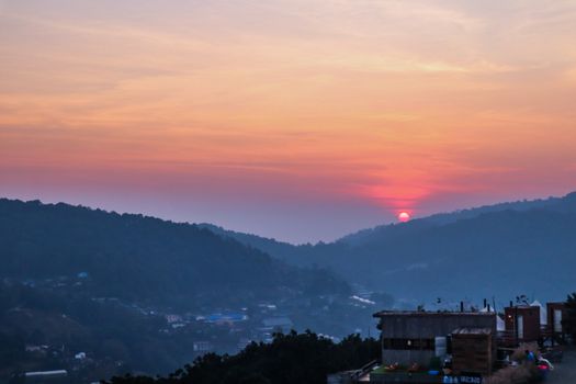 Vivid sunset in a thai village near mountains in Chiang Mai, Thailand. The mountain scenery view