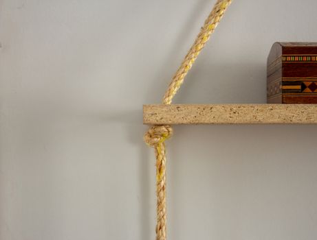 Sisal rope shelf made with old planks and a old wood chest on top of it