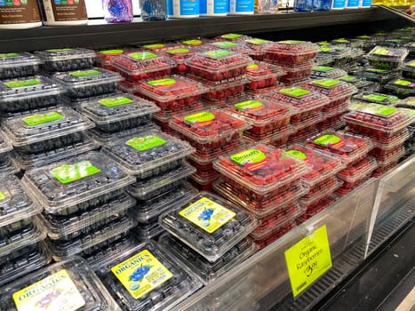 Orlando,FL/USA -5/10/20:  Boxes of raspberries and blueberrie at the fresh produce aisle of a Whole Foods Market grocery store.
