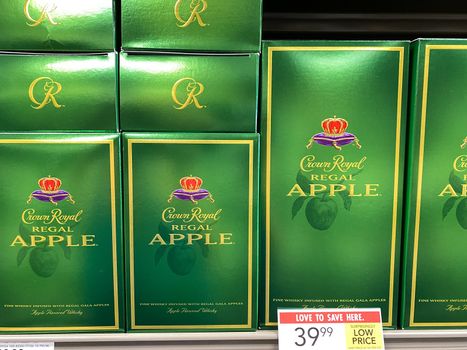 Orlando,FL/USA -5/13/20: A display of Crown Royal Regal Apple Canadian Whiskey at a Publix liqour store.