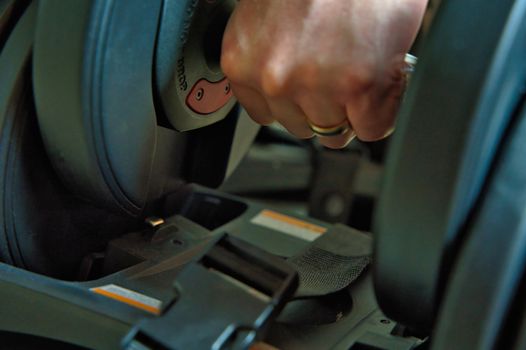 Hand gripping adjustable dumbbells for working out at home. male hand with ring visible.