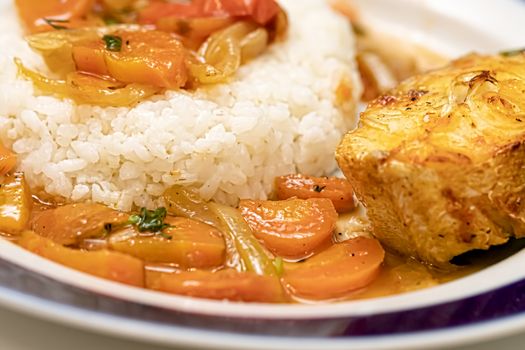 Fish is baked in the oven with onions and carrot slices and served with a side dish of rice. Flexitarian Diet Concept