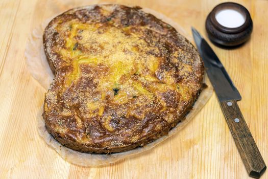 Homemade yeast-free cake on kefir with a filling of canned fish and potatoes, close-up. A hearty dish for a Flexitarian