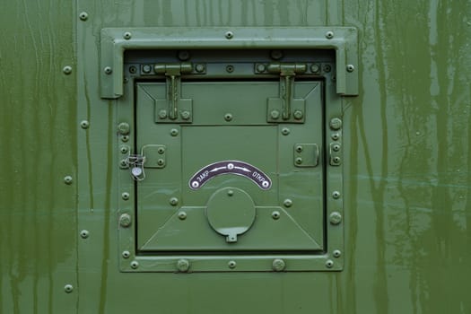 dark green cover on board a military vehicle, with pointer and seal